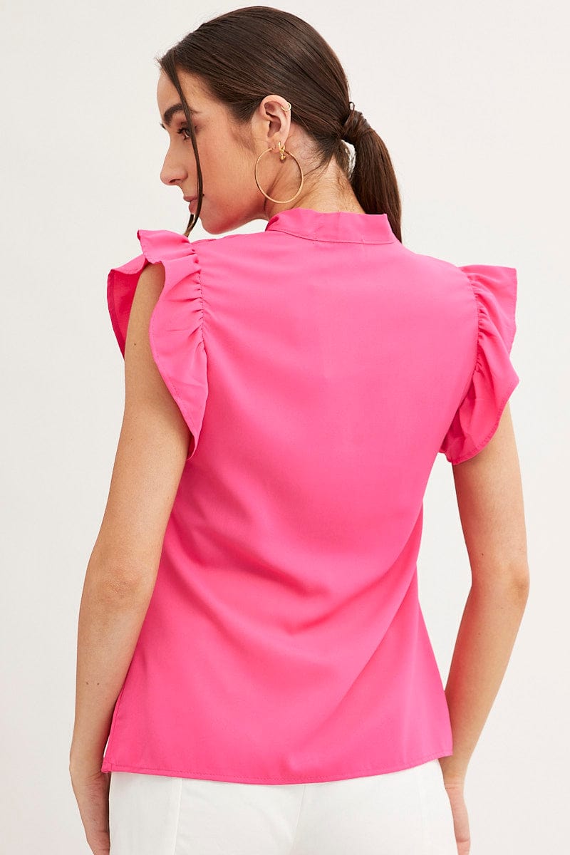 Outfit wearing pink trousers and a ruffle sleeve top